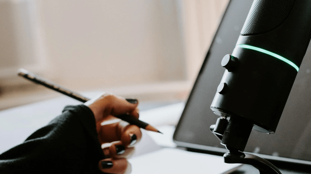 content marketer sitting at a microphone preparing content for a podcast